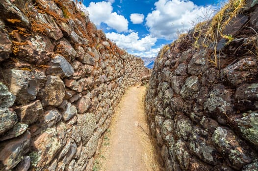 Narrow passage in the ruins of Pisac in the Sacred Valley near Cusco, Peru