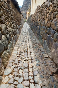 Narrow alley in the small historic town of Ollantaytambo in the Sacred Valley near Cusco, Peru