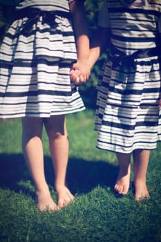 Girls holding hands. Exterior shot.