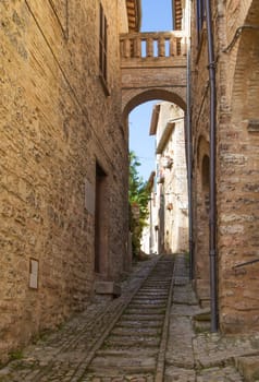 The narrow street in the historic center of Spello (Umbria, Italy)