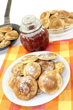 baked Poffertjes against a white background