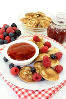 baked poffertjes with raspberries and blueberries
