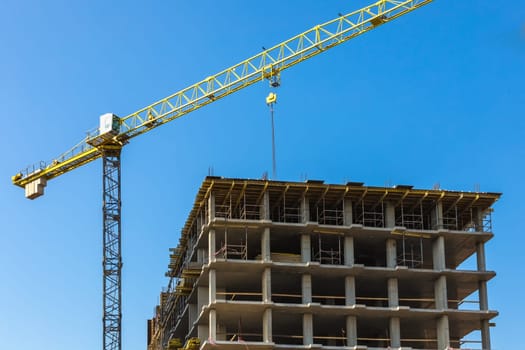 Construction crane on building site on sky background