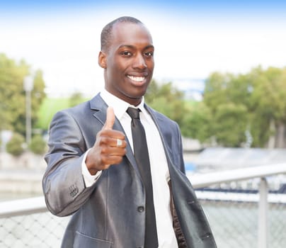 Portrait of a confident businessman with thumb up