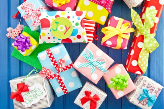 Small gifts in colorful paper on blue