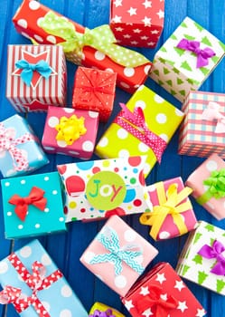 Small gifts in colorful paper on blue