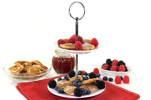 Poffertjes with raspberries and blueberries on one floor