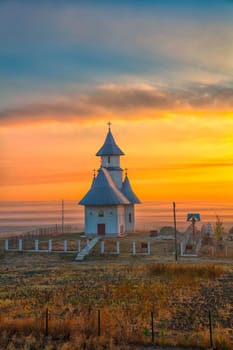 Landscape of the church in a small village in Romania at sunrise.
