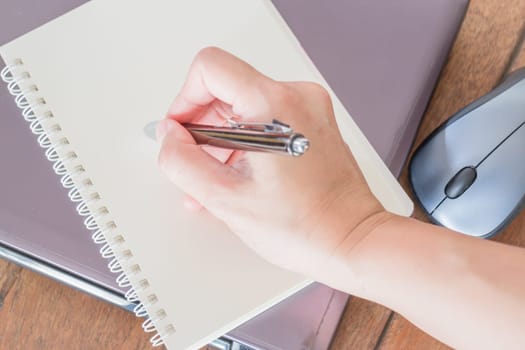 Hand writing on note paper at workplace, stock photo