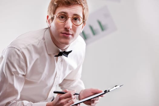annoying redheaded clerk with glasses and a notepad asking more precision