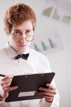 a redheaded clerk with glasses looking at you with suspicion
