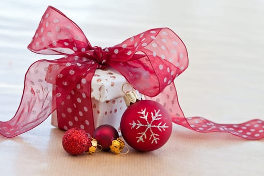 Small gift box with red ribbon and Christmas decoration