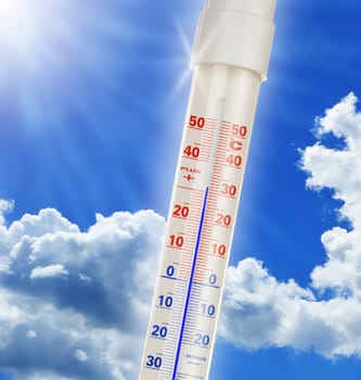 Alcohol thermometer over blue sky.