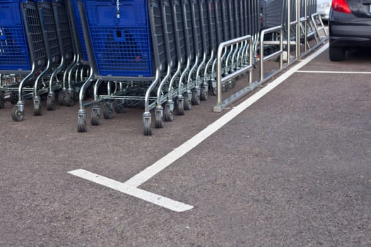Blue shopping carts on a parking lot outdoors the mall