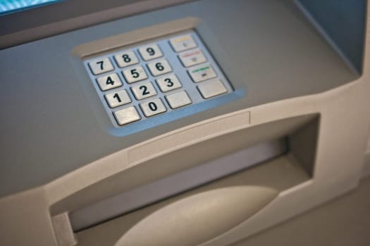 Gray and blue keypad of an automated teller machine