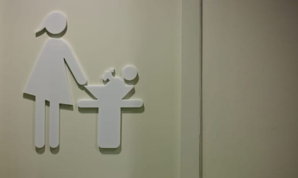 Door with pictogram of breastfeeding and changing room in a shopping center