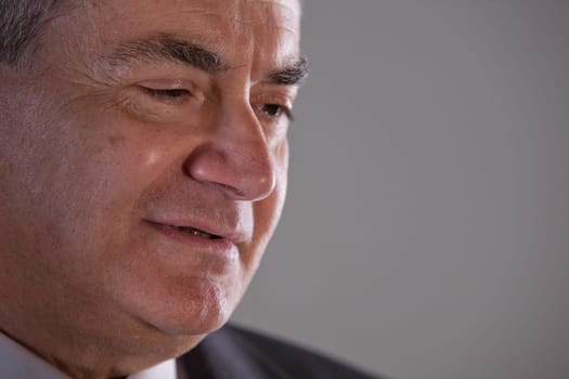 Senior executive man (or a grandfather) smiling and looking into the future