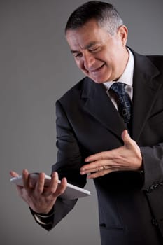 An old manager using successfully and with satisfaction a tablet