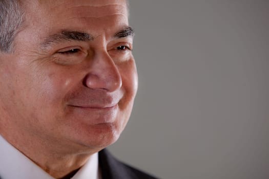 Senior executive man (or a grandfather) smiling and looking into the future