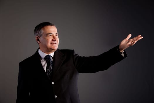Senior executive raising a hand showing something