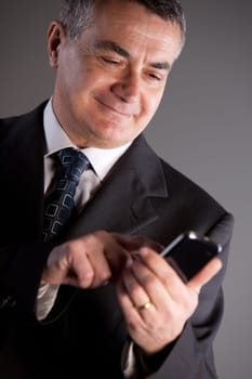 A senior manager using successfully his inseparable smartphone agenda and calendar