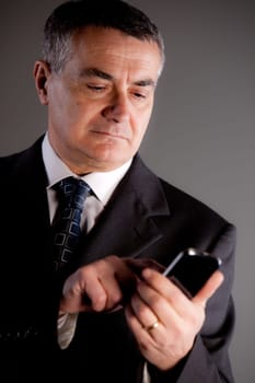 A senior manager using successfully his inseparable smartphone agenda and calendar