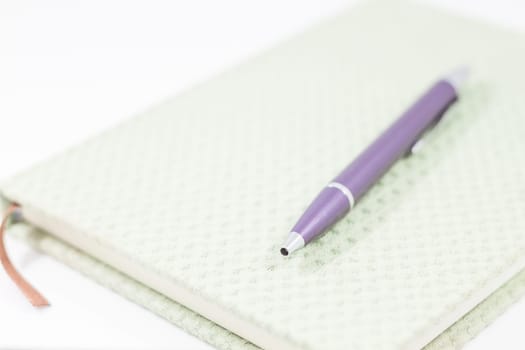 Closeup notebook with pen on white background, stock photo