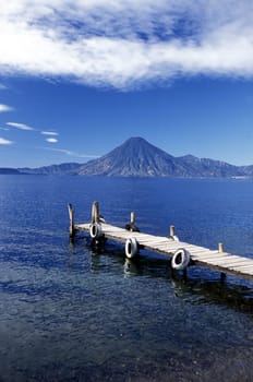 The Lake Atitlan with the Volcanos of Toliman and San Pedro in the back at the Town of Panajachel in Guatemala in Central America.