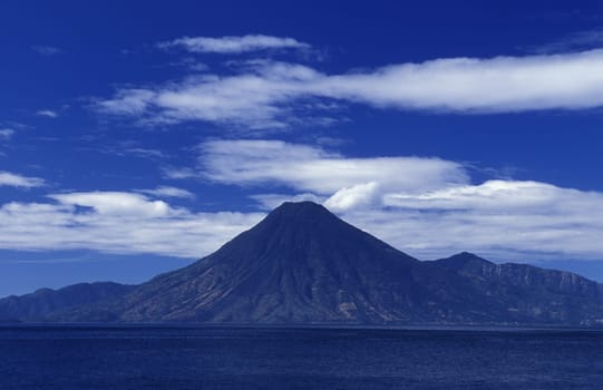 The Lake Atitlan with the Volcanos of Toliman and San Pedro in the back at the Town of Panajachel in Guatemala in Central America.