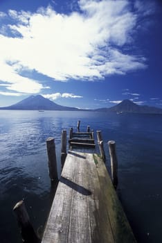 The Lake Atitlan with the Volcanos of Toliman and San Pedro in the back at the Town of Panajachel in Guatemala in Central America.