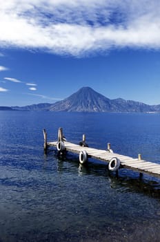 The Lake Atitlan with the Volcanos of Toliman and San Pedro in the back at the Town of Panajachel in Guatemala in Central America.