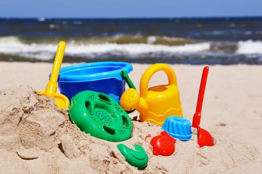 Plastic children toys on the sand beach.