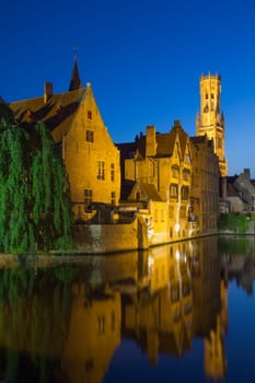 Night view from the Rozenhoedkaai of the Old Town of Bruges (Bruges, Belgium). Vertically.