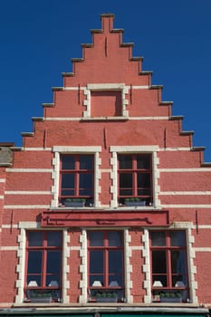 Red gable roof of the historic house (Bruges, Belgium). Front view.