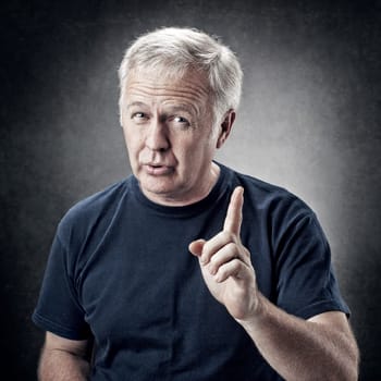 Old man emphasizing an idea for someone