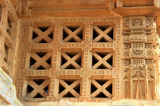 X-shaped red stone window panes at Vijay Sthambh (Victory Tower), Chittorgarh Fort, Rajasthan, India, Asia