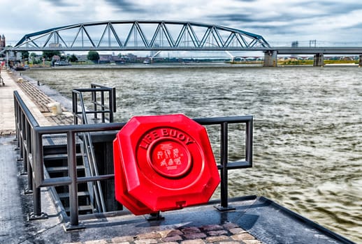 orange safety life buoy on a river quay in hdr