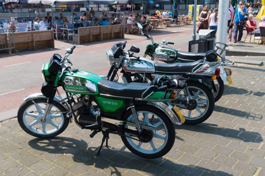 oldtimer zundapp mopeds parked on a sidewalk in Nijmegen, netherlands. The name "Zündapp"" is a contraction of the company name ""Zunder und Apparatenbau GmbH Nürnberg""."