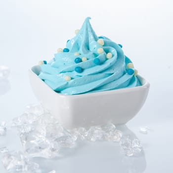 Close up Frozen Yummy Yogurt on Bowl Surrounded by Ice Isolated on White Background.