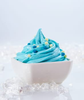 Close up Delicious Light Blue Frozen Yogurt on White Bowl with Ice Pieces on sides. Isolated on White Background.