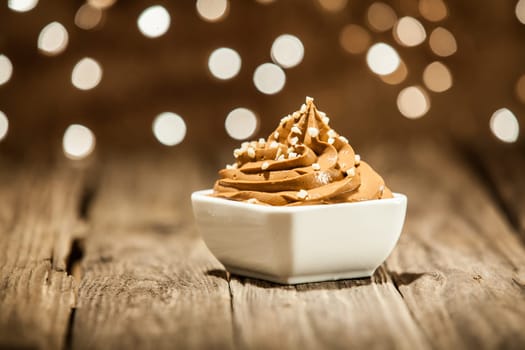 Macro Mouth Watering Brown Frozen Yogurt on Bowl Placed on Wooden Table