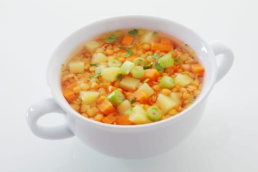Nutritious vegetarian cuisine with a bowl of lentil, leek and carrot soup, rich in protein and dietary fiber