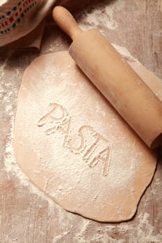 Homemade Flat Fresh Pasta Dough, Flattened by Wooden Roller, on Wooden Table