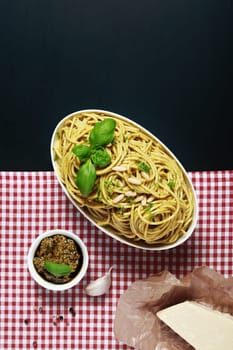 Appetizing Italian Recipes on Red and White Checkered and Black Background. Emphasizing the Mouth Watering Pasta on White Bowl.