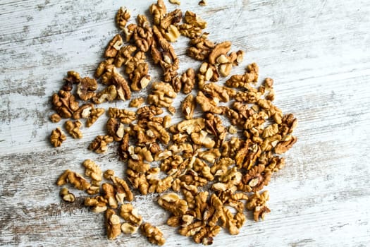 Many Walnuts over a wooden table, background.