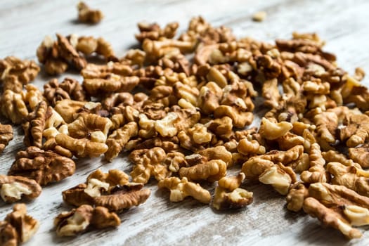 Many Walnuts over a wooden table, background.