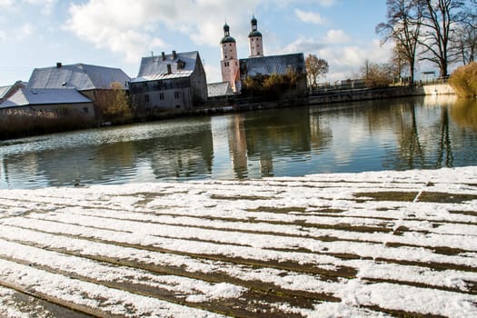 Snowy Panorama of Wending (municipality in the district of Bavaria, Germany) with St. Emmeram church in the background.
