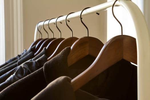 Winter clothes hanged on a clothes rack.