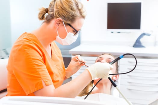 Patient has professional dental cleaning at the dentist