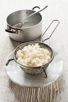 Making Fresh cottage cheese on wooden background